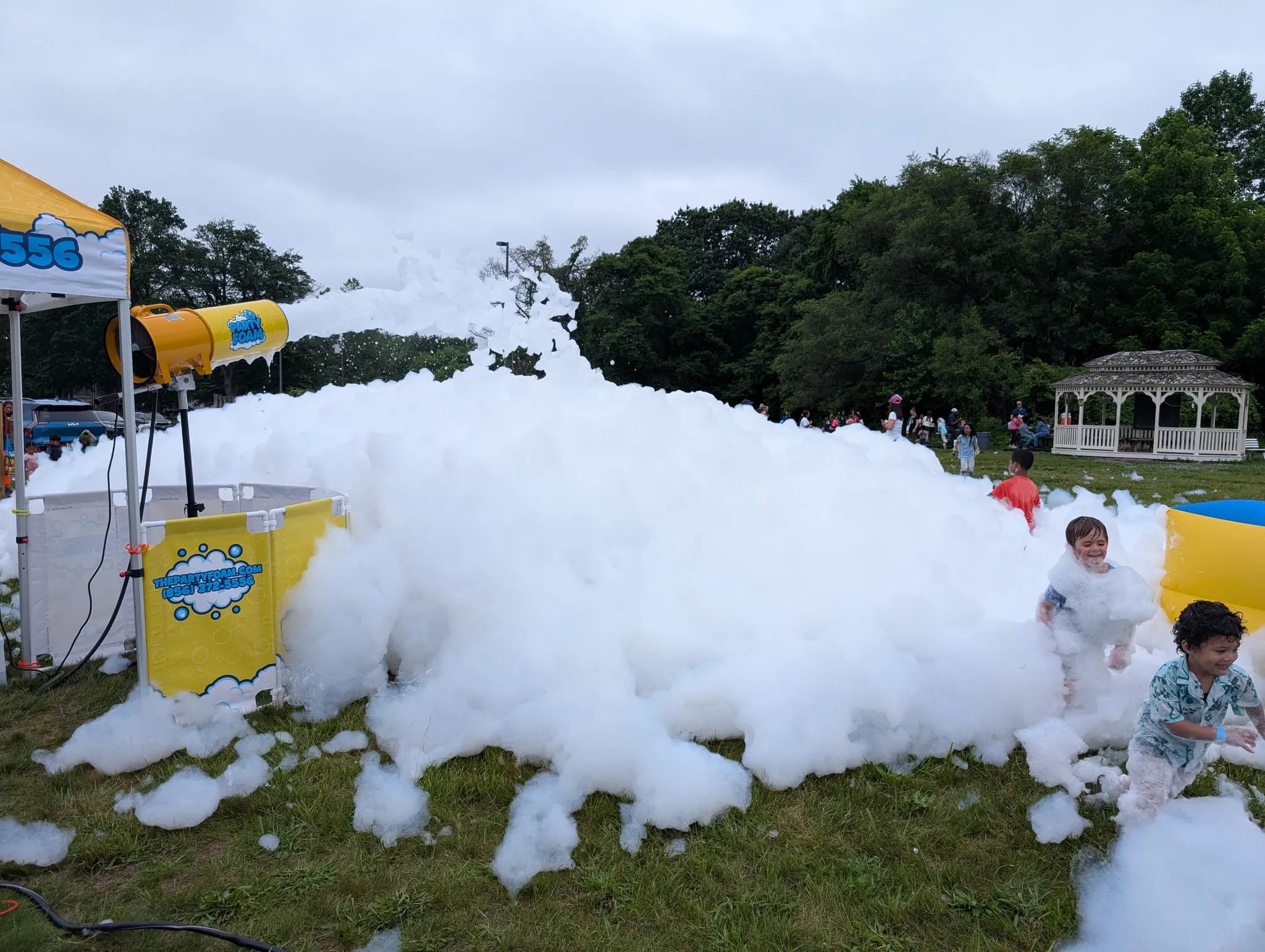 Kids playing in foam at a school foam cannon event in New Jersey