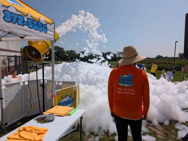 Party Foam operator overseeing a foam cannon party setup in a South Jersey backyard