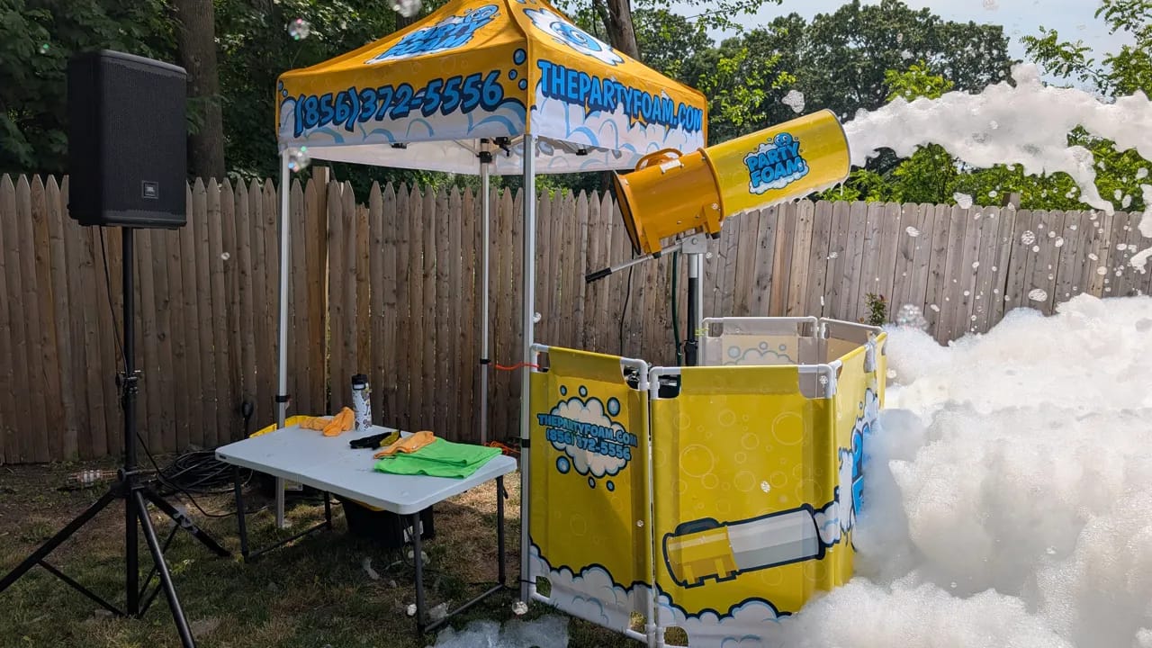 Party Foam branded tent, foam cannon, and contained foam pit rental set up in a South Jersey backyard
